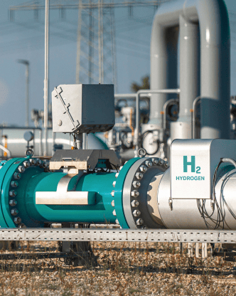 Hydrogen pipeline marked "H₂" in an outdoor industrial setting.
