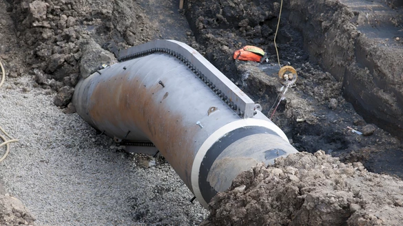 Grey gas pipeline exposed at the ground at North Rigton
