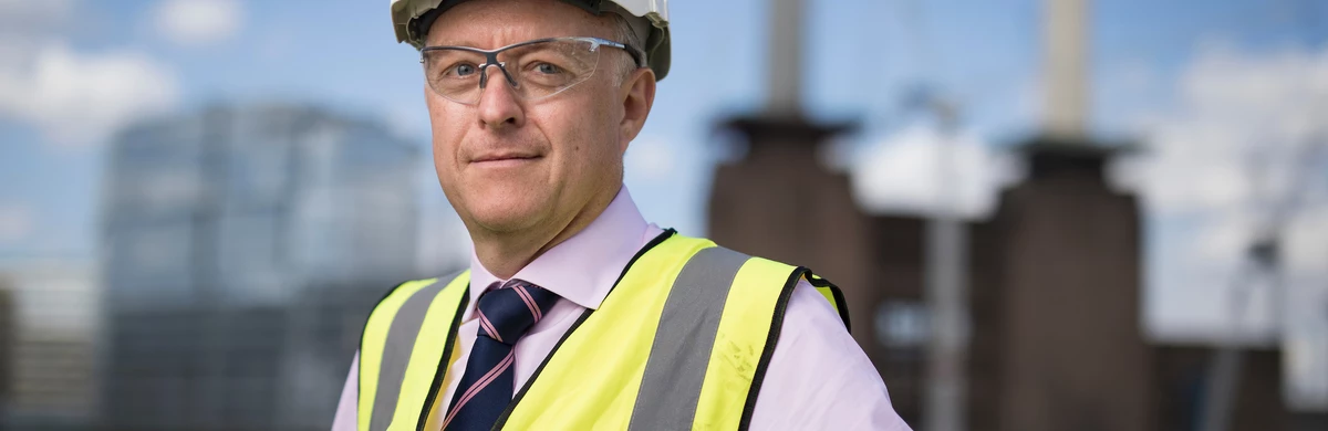 National Grid Head of Real Estate Phil Edwards portrait with out of focus Battersea site in the background 