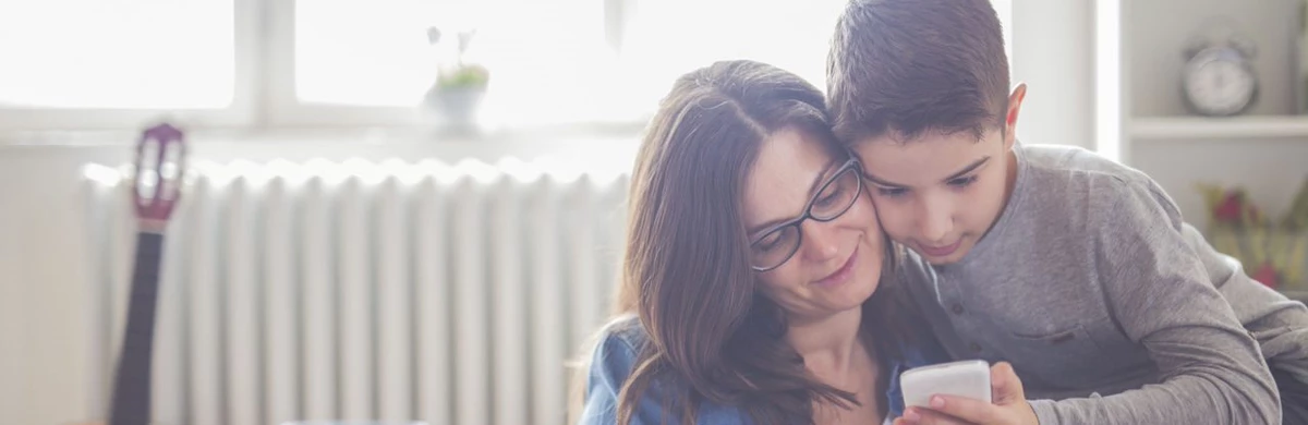 Mother and son looking at phone