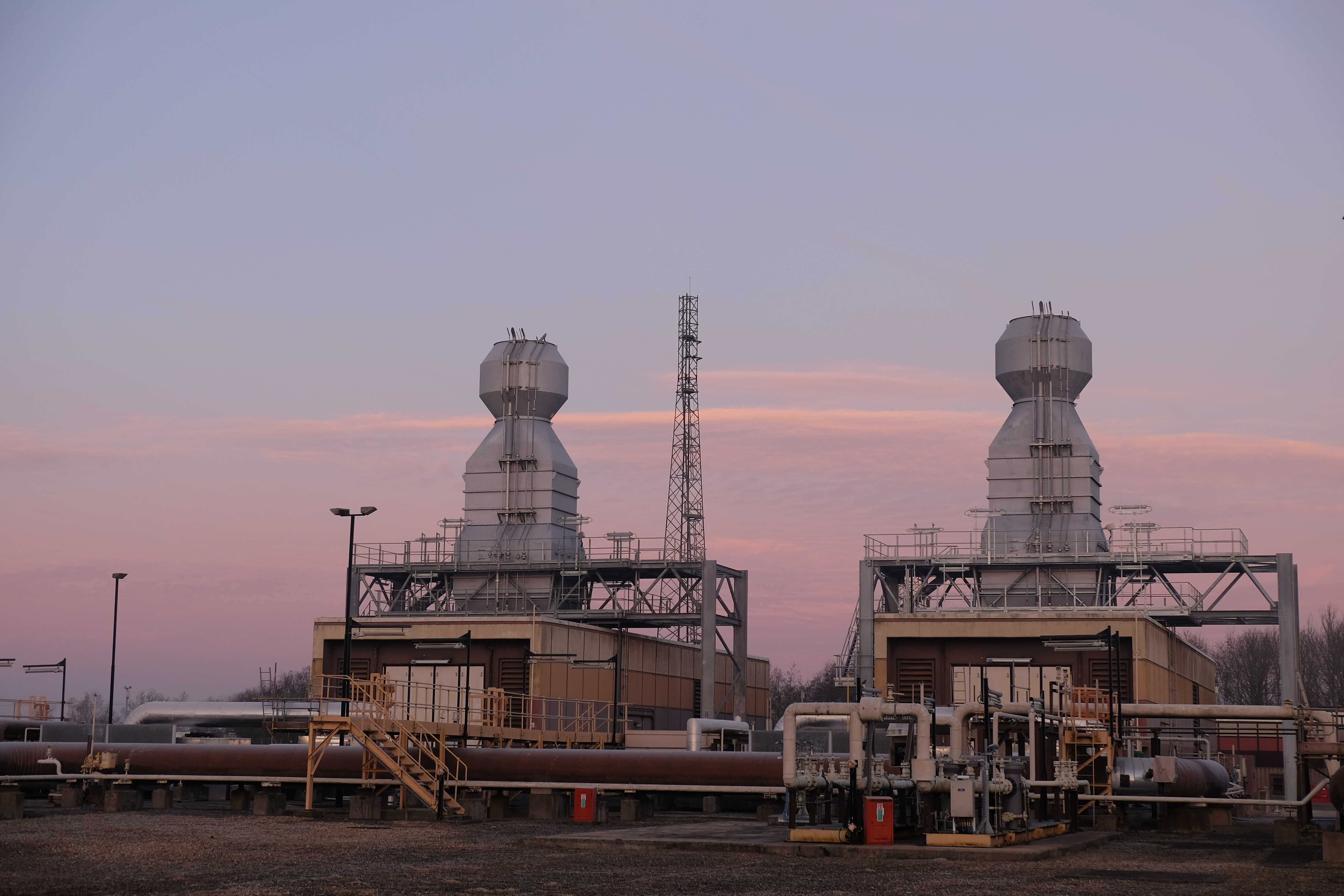 Two industrial work sites at dusk 